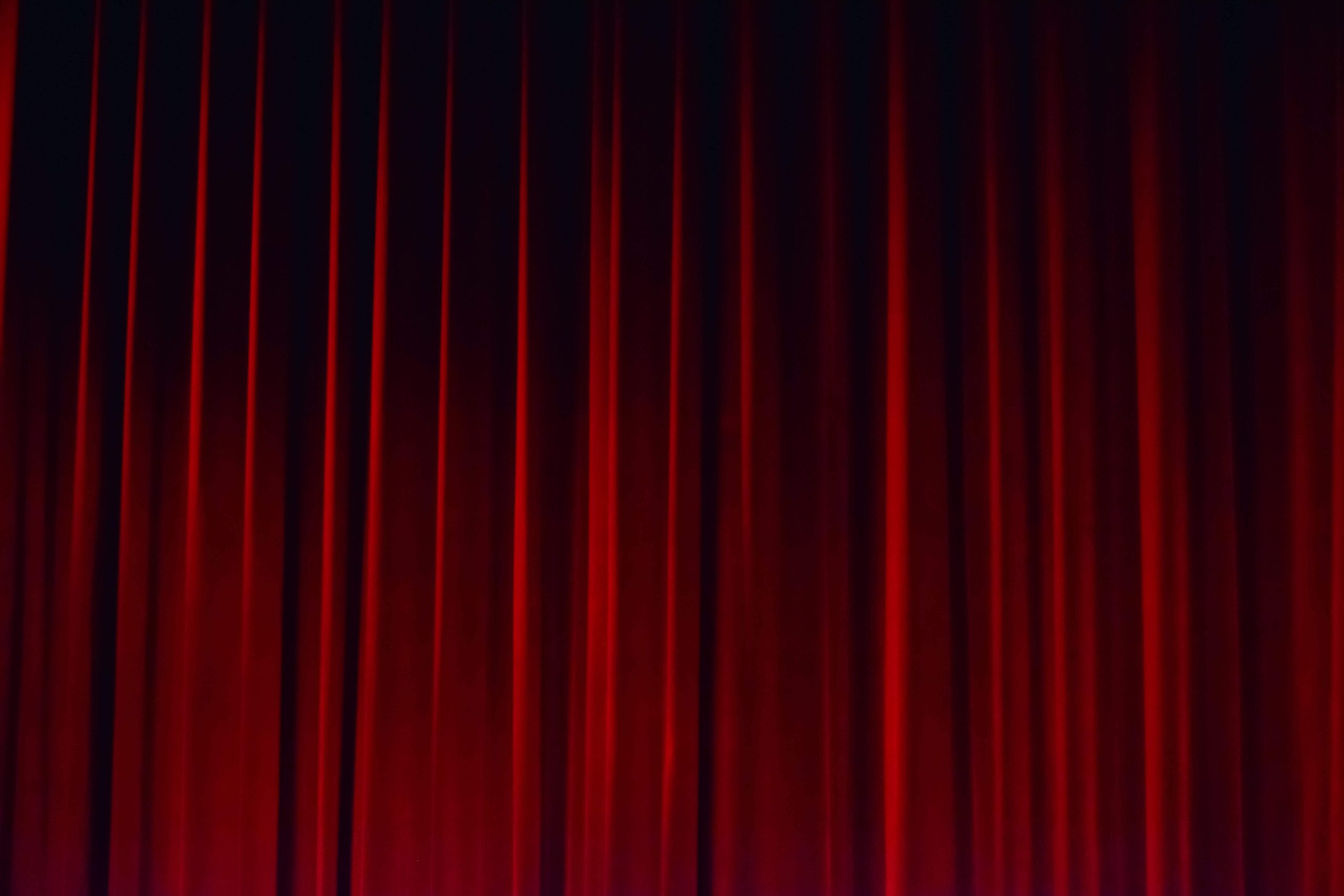 A closed red theatre curtain.