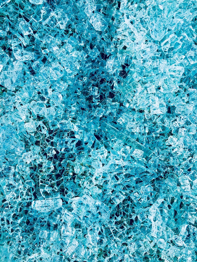 A field of shattered pale blue safety glass.
